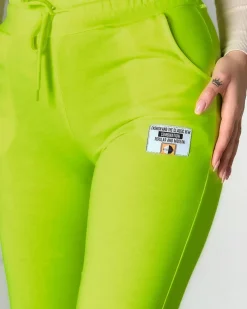 Neonowe żółte damskie spodnie dresowe z naszywką- Odzież