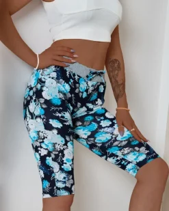 Royalfashion Ciemnoniebieskie damskie spodenki 3/4 z kwiatowym wzorem