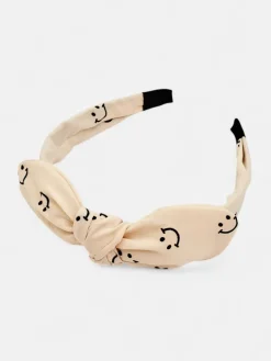 Royalfashion Dziecięca opaska do włosów z kokardką z printem w uśmiechnięte buźki