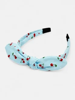 Royalfashion Dziecięca opaska do włosów z kokardką z printem w wisienki