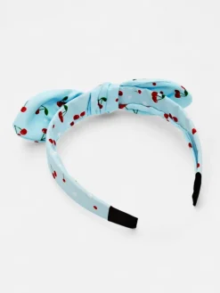 Royalfashion Dziecięca opaska do włosów z kokardką z printem w wisienki