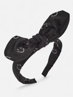 Royalfashion Dziecięca opaska do włosów z kokardką z printem w uśmiechnięte buźki